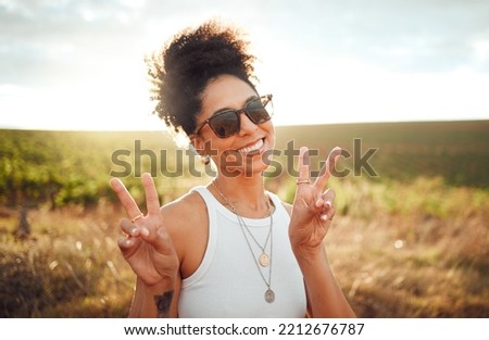 Black woman smile, peace hand sign and happy countryside nature at summer sunset. African American girl, portrait of calm young beauty and happiness on a travel holiday trip to South Africa wine farm