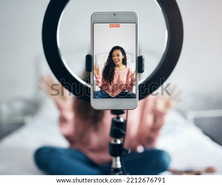 Live streaming, phone and black woman talking on video podcast in the bedroom of her house. Happy and excited girl or influencer speaking on the internet or social media with a mobile and ring light Royalty-Free Stock Photo #2212676791