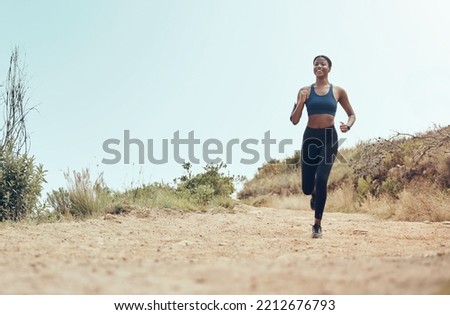 Fitness, running and black woman on nature trail for marathon cardio exercise in Hollywood USA. African American athlete enjoying outdoor run for training and cardiovascular health lifestyle. Royalty-Free Stock Photo #2212676793