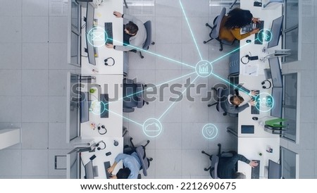 Top Down Footage of a Busy Corporate Office with Tow Rows off Businessmen and Businesswomen Working on Desktop Computers. VFX Edit of Connected Technological Social Network Between Colleagues. Royalty-Free Stock Photo #2212690675