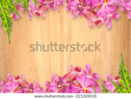 Old wooden background with pink Orchid flowers frame
