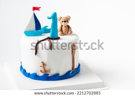 boat and doll bear fondant on vanilla cake on white background, Homemade cake concept