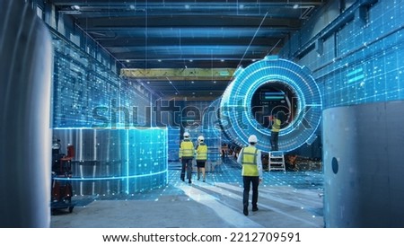 Futuristic Technology: Team of Engineers and Professionals Workers in Industry Manufacturing Factory that is Digitalized with Graphics into Connected Automated Machinery. High-Tech Industry 4.0.