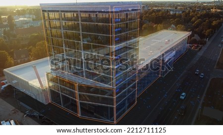 Aerial Drone Footage with VFX Concept: Building Construction Site Becomes Finished Project with 3D Graphics Effects On Image. Visualization, Digitalization of Design, Development of Megapolis City. Royalty-Free Stock Photo #2212711125
