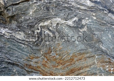 Abstract texture of natural gneiss foliated metamorphic rock background. Royalty-Free Stock Photo #2212712473
