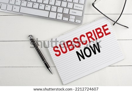 text SUBSCRIBE NOW on keyboard on white background