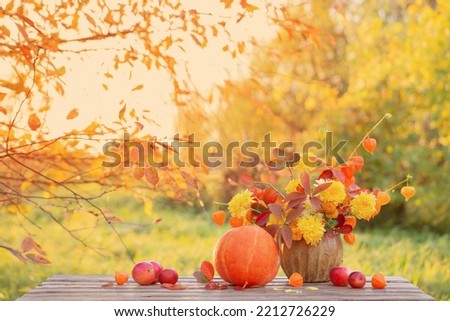 beautiful autumnal  bouquet on wooden table in garden