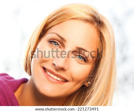 Young woman smiling and enjoying early spring sunshine