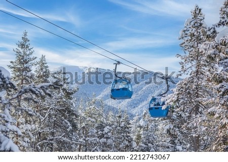 Bansko, Bulgaria winter ski resort panorama with blue gondola lift cabins, snow forest pine trees, mountain peaks view Royalty-Free Stock Photo #2212743067