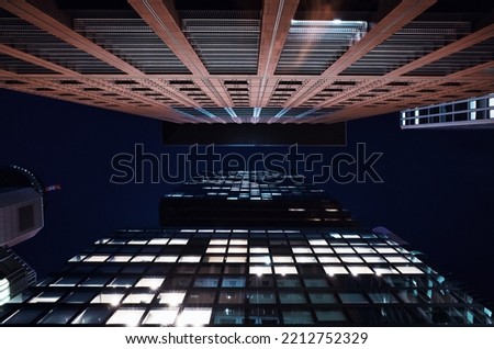 looking up to modern high rise office buildings at night