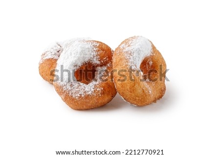 Donuts with powdered sugar isolated on a white plate. Circle Donuts fried in oil without icing. Doughnut pastry, potato donuts. Pyshki.