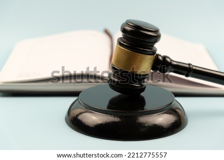 Gavel and block on blue background