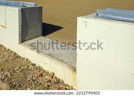 prepared base and concrete border for installation of inflatable playing arena, football hall, air dome on blue sky background Royalty-Free Stock Photo #2212790403