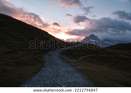 Colorful summer sunrise on Bachalpsee lake with Schreckhorn and Wetterhorn peaks on background. Picturesque morning scene in the Swiss Bernese Alps, Switzerland, Europe.