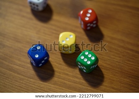 Colourful dices on a wooden table 