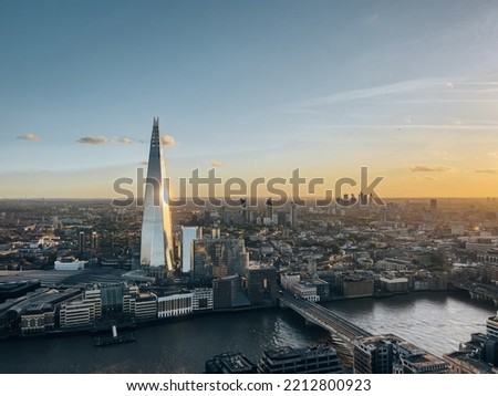 Aerial view on the Shard tower in central London with river Thames and bridge during sunset