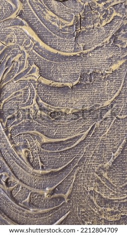 Detail or close-up photography of a high-relief texture in gold and black, things from traditional life.
