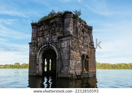 Old flooded ruined abandoned church. Ancient ruins on water Royalty-Free Stock Photo #2212810593