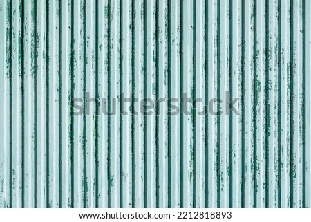 Blue old corrugated metal fence background.