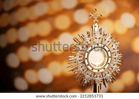 Catholic theme. Golden monstrance on bokeh background. Royalty-Free Stock Photo #2212853731