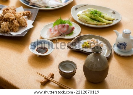 Japanese dining table with sake during dinner at home, home cooking
