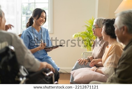Group of asian senior people listening to young nurse. Psychological support group for elderly and lonely people in a community centre. Group therapy in session sitting in a circle in a nursing home. Royalty-Free Stock Photo #2212871121