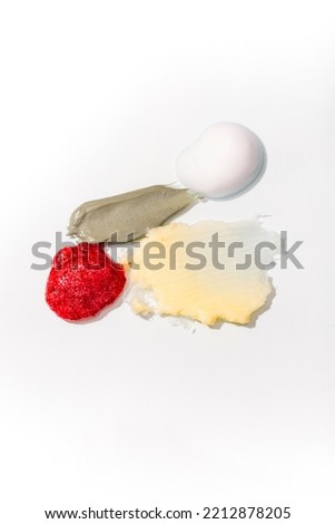 Cosmetic smears and drops. Appearance of the texture of the cream, oil and granules on a white background. Natural skincare products. Beauty concept for face and body care