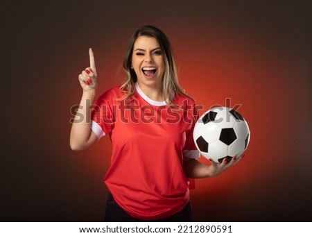 woman soccer fan cheering for her favorite club and team. world cup red background.