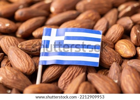 Flag of Greece on almonds. Origin of nuts, agribusiness of growing almond nuts in Greece