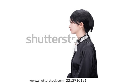 A girl with short hair dressed in black