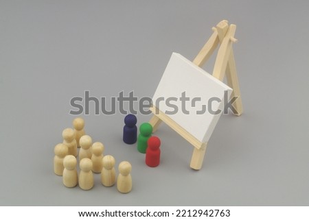 Three colored people figures and common figures with easel and blank canvas. Presentation and seminar concept.