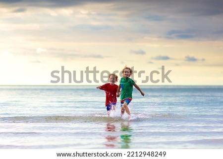 Child playing on tropical beach. Little baby boy at sea shore. Family summer vacation. Kids play with water and sand toys. Ocean and island fun. Travel with young children in Asia.