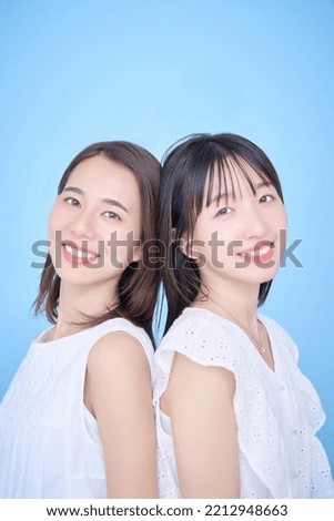 Two women in white clothes fit in a photo