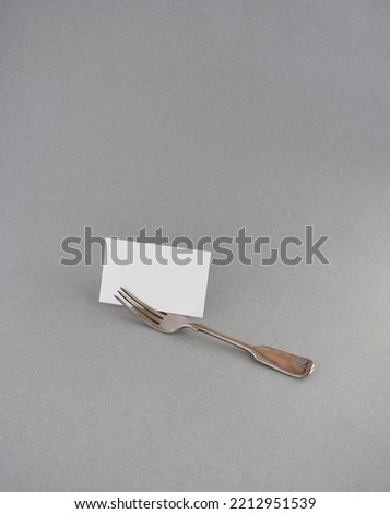 blank paper and knife on gray background