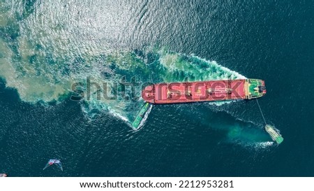 Tug Boat drag Barge ship carry Metal steel pipe construction unit , No International Sewage sludge Pollution Prevention Certificate, Sewage Sludge in the sea made by Activity of ship concept Royalty-Free Stock Photo #2212953281