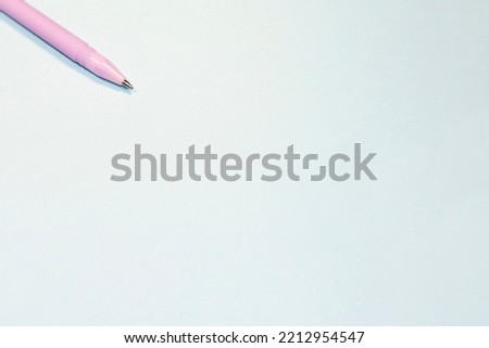 Ballpoint pen on a blue isolated background. Stationery items. Subject for writing