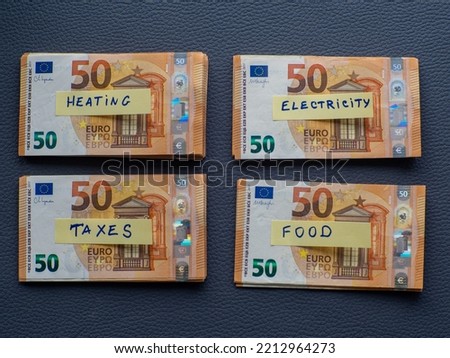 Four stack of money with inscription on the sheets for savings, cash money, euro banknotes on dark background. Home budget planning for Heating, electricity, taxes and food. Savings for life and food