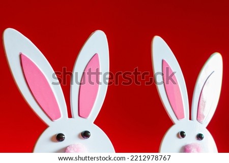 Two Toy Rabbit Bunny symbol of new year 2023 on red background.Christmas or New Year concept.Copy space.Closeup.