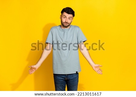 Photo of funky millennial brunet bristle man dont know no idea shrug shoulders forgot his money home before cinema isolated on bright yellow color background