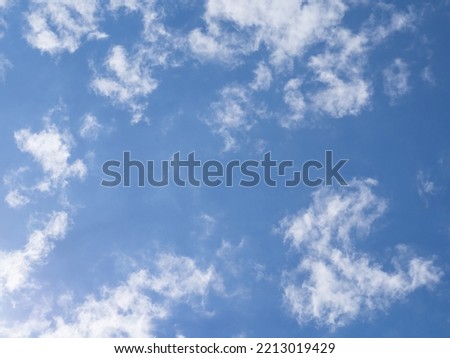 Blue sky and light white clouds illuminated by light on a sunny day. Amazing sky background for design or wallpaper