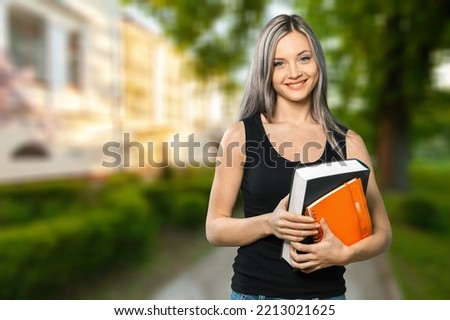 Happy female student walking outdoors