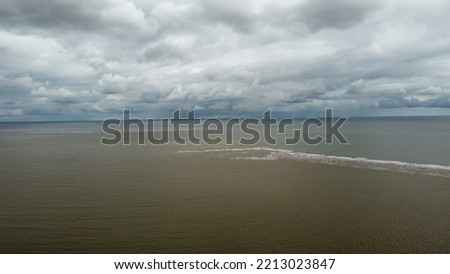 Aerial view looking down onto sea and a sandy beach. Lowestoft England. 