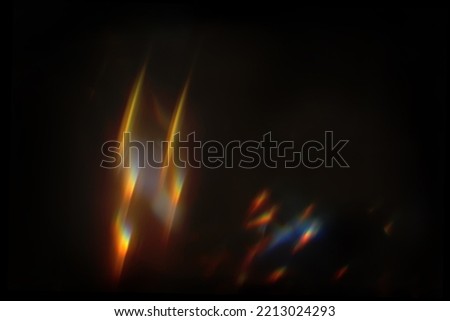 Abstract lens flare light over black background. Lens flare lights. Bokeh Prism Light Flares Overlay on Black Background. abstract Bokeh Lights. light leak. natural light effects. Royalty-Free Stock Photo #2213024293