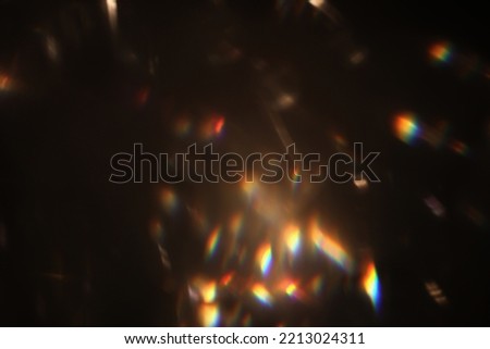 Abstract lens flare light over black background. Lens flare lights. Bokeh Prism Light Flares Overlay on Black Background. abstract Bokeh Lights. light leak. natural light effects. Royalty-Free Stock Photo #2213024311