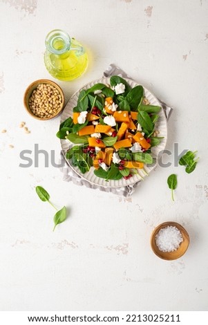Overhead view of roasted butternut pumpkin vegan salad on white plate