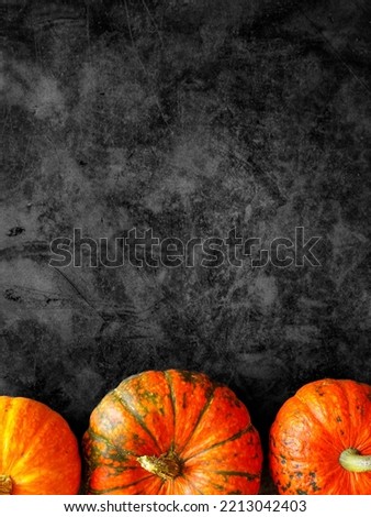Halloween background with orange pumpkins border on black marble. Happy Halloween holiday sale, discount, promotion banner template. Top view, copy space, vertical