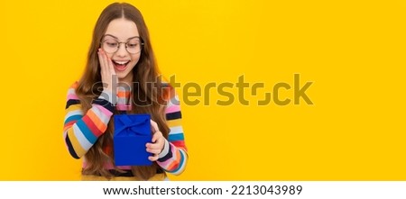shopping child with purchase. kid with box. happy birthday holiday surprise. Teenager girl with birthday gift, horizontal poster. Banner header with copy space.