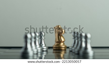 Leadership.  teamwork and business strategy concept,gold queen with silver chess pieces on chess board game competition on dark background, chess battle, 
team leader,,victory, success, management