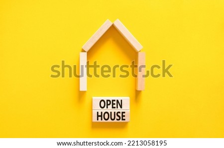 Open house symbol. Concept words 'Open house' on wooden blocks near miniature house. Beautiful yellow background, copy space. Business and open house concept.