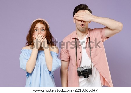 Two shocked traveler tourist woman man couple wearing casual clothes cover eyes mouth with hand isolated on purple background. Passenger travel abroad on weekends getaway. Air flight journey concept.